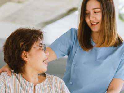 caregiver attending to elderly woman on wheelchair