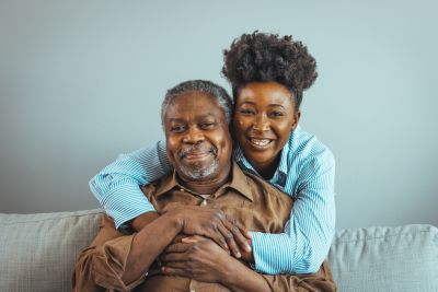 caregiver smiling with elderly man