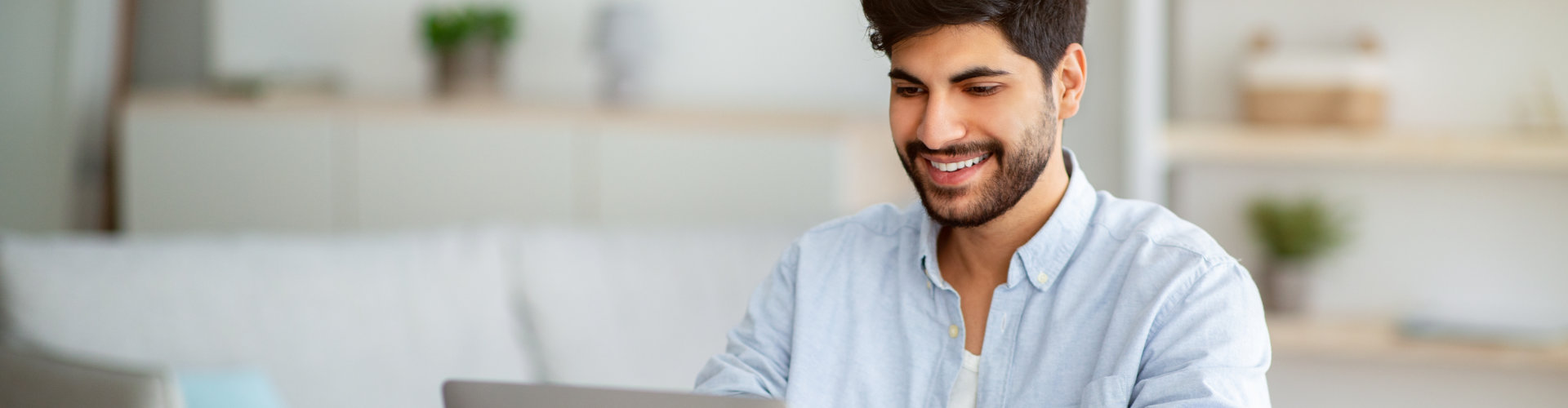 man typing on laptop